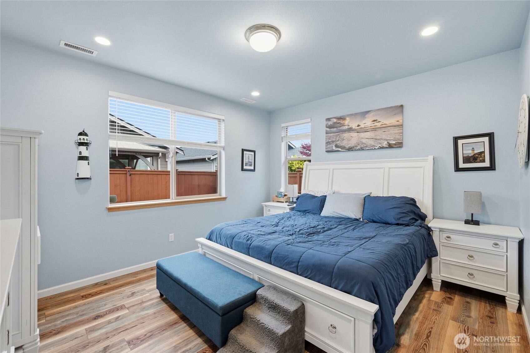 8218 Bainbridge Loop Northeast Lacey, WA 98516 - Photo 24 of 40 a bedroom with a bed and wooden floor