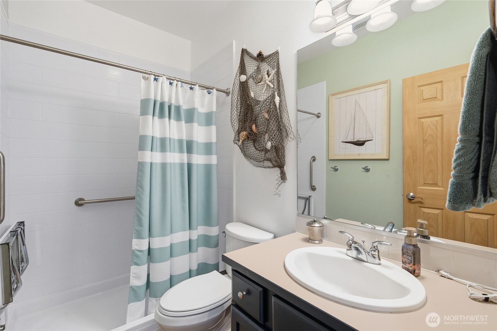 8218 Bainbridge Loop Northeast Lacey, WA 98516 - Photo 26 of 40 a bathroom with a sink toilet and shower