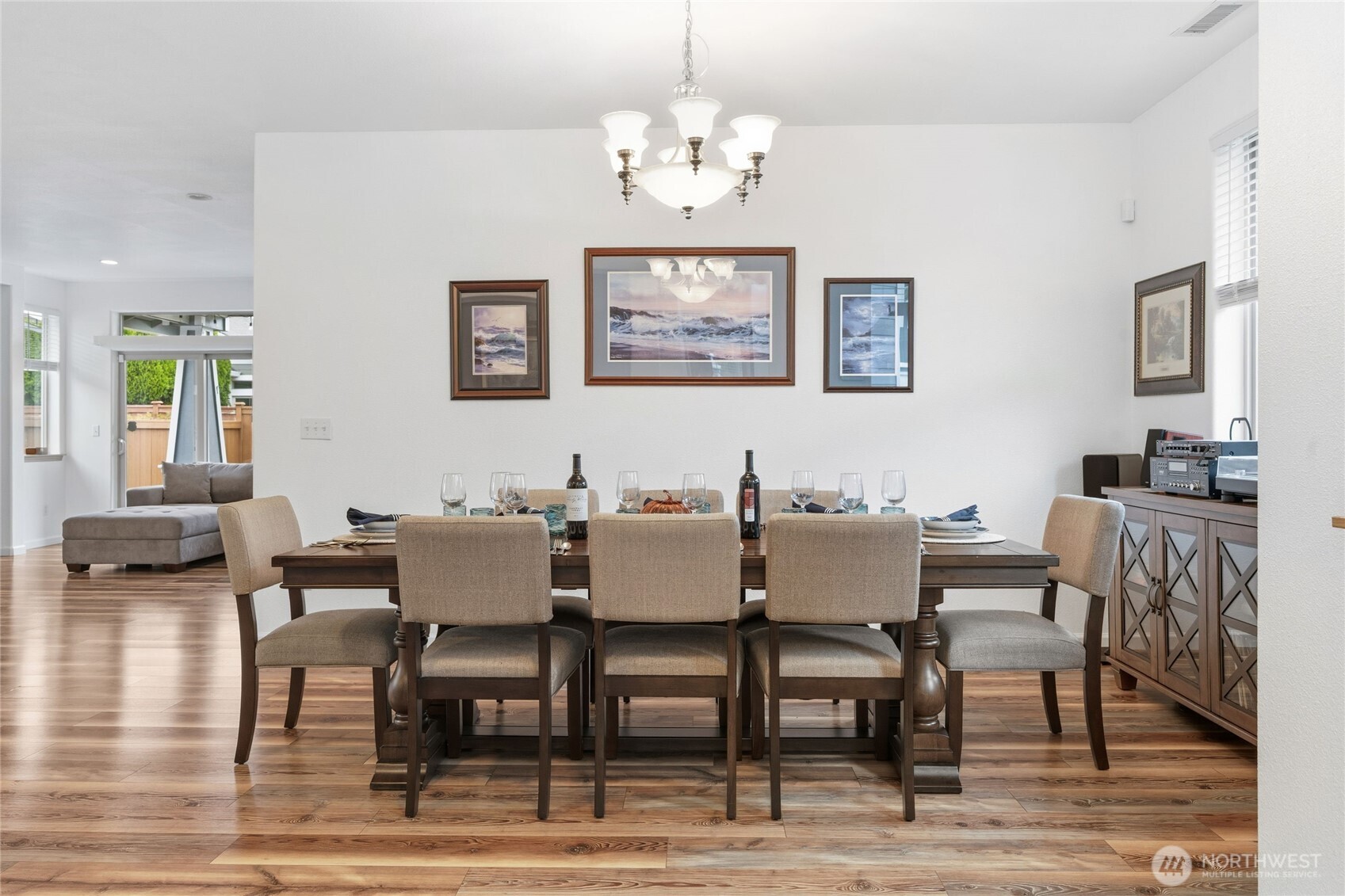 8218 Bainbridge Loop Northeast Lacey, WA 98516 - Photo 7 of 40 a view of a dining room with furniture a chandelier and wooden floor