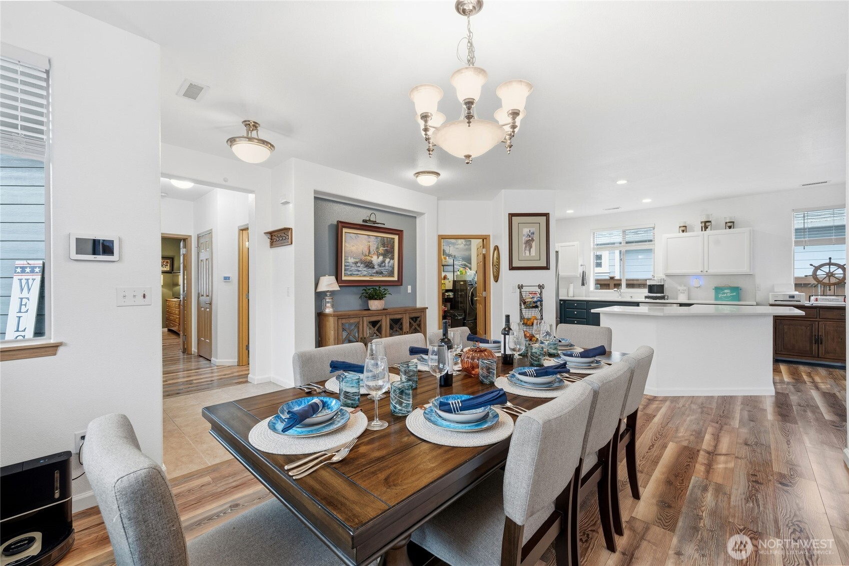 8218 Bainbridge Loop Northeast Lacey, WA 98516 - Photo 8 of 40 a view of a dining room and livingroom with furniture wooden floor a chandelier