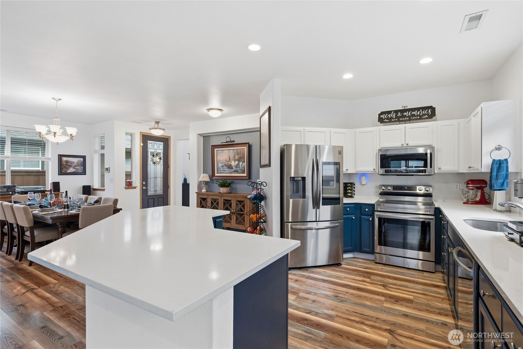 8218 Bainbridge Loop Northeast Lacey, WA 98516 - Photo 10 of 40 a kitchen with stainless steel appliances a stove refrigerator sink and cabinets