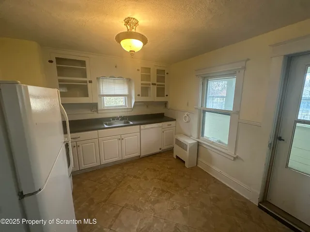 a kitchen with stainless steel appliances a refrigerator and a sink