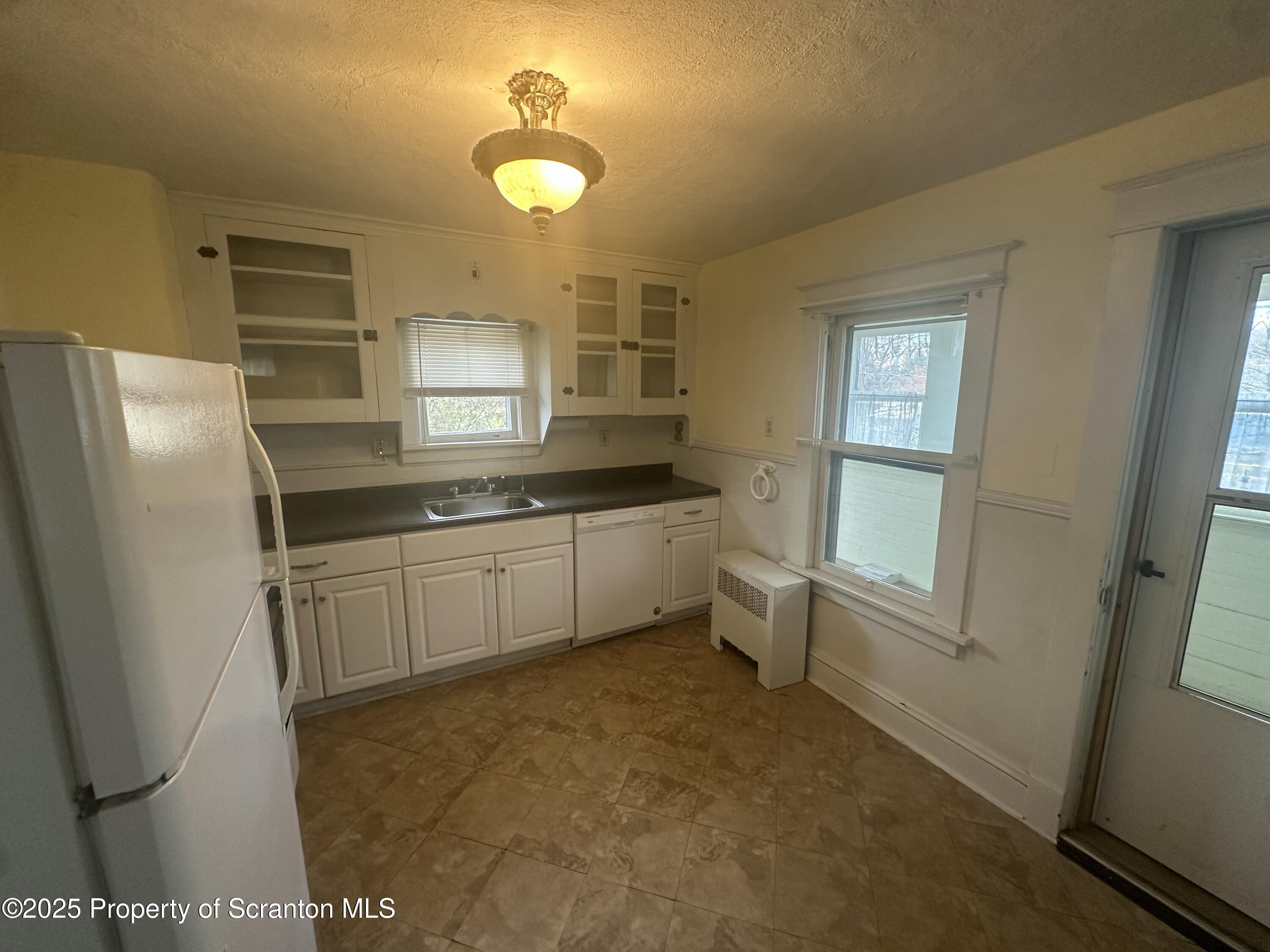 1906 Farr Street, Unit 2 Scranton, PA 18504 - Photo 3 of 14 a kitchen with stainless steel appliances a refrigerator and a sink