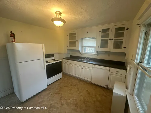 a kitchen with a refrigerator a stove a microwave and cabinets