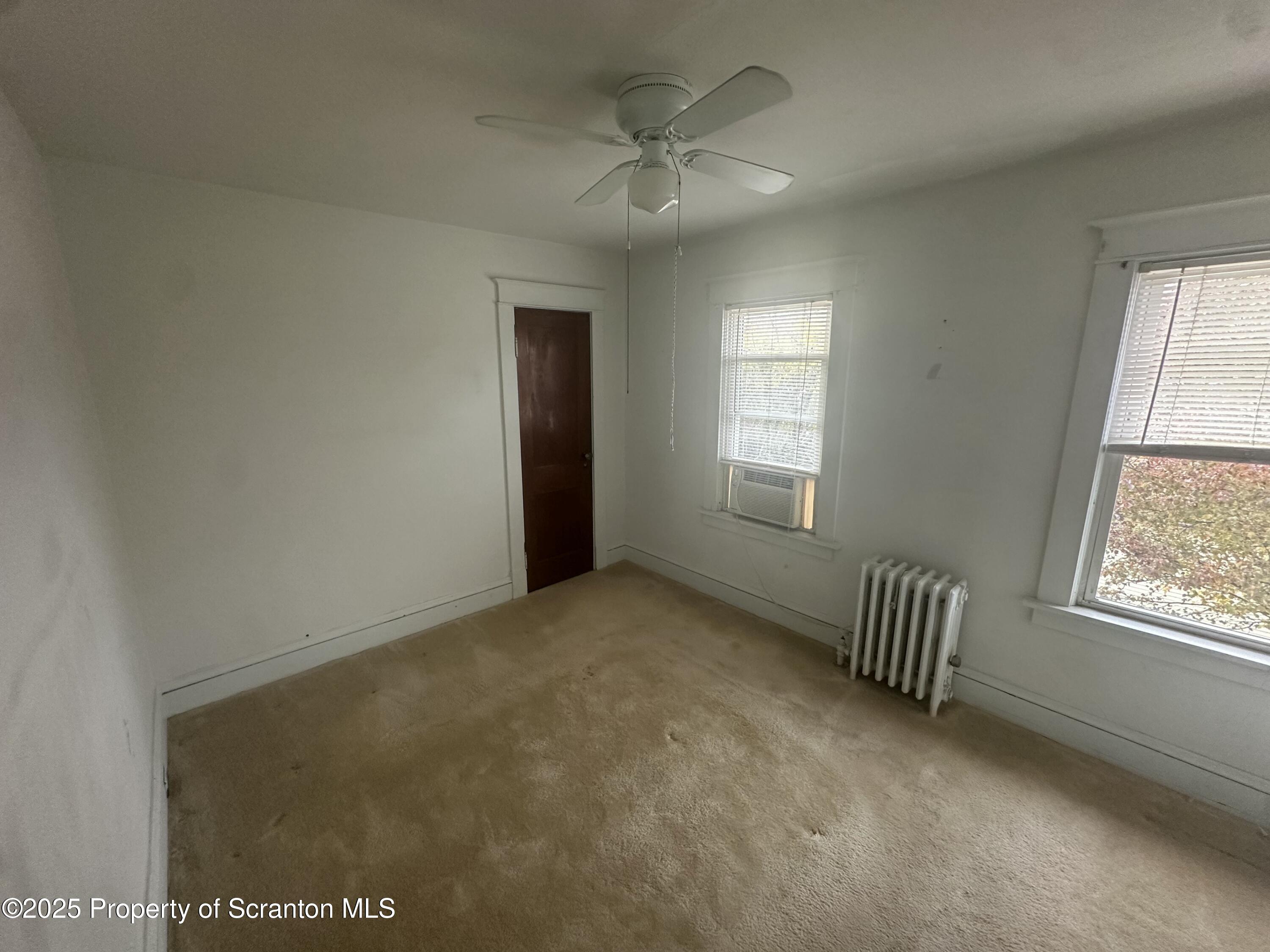 1906 Farr Street, Unit 2 Scranton, PA 18504 - Photo 9 of 14 an empty room with windows and ceiling fan