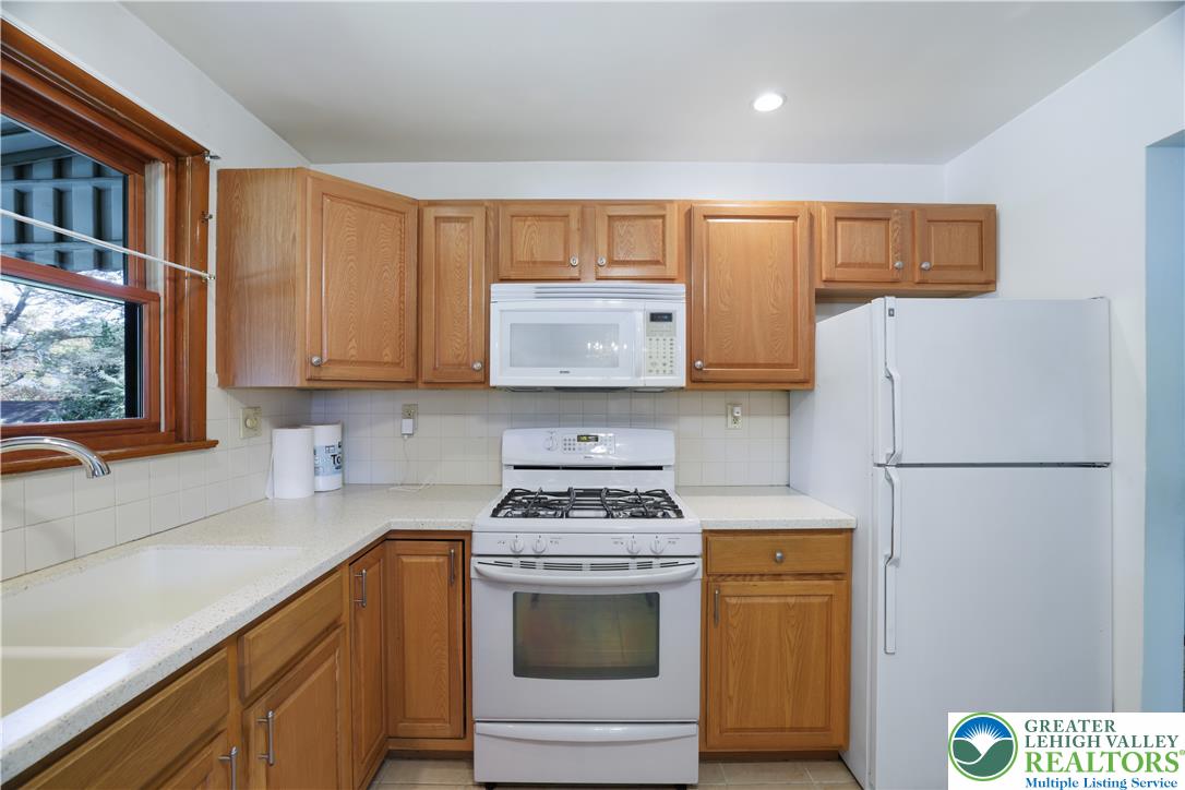 1539 Spring Garden Street Wilson, PA 18042 - Photo 11 of 34 Ample wooden cabinetry and classic appliances define this highly functional culinary space.