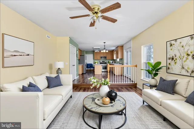 a living room with furniture potted plant and a chandelier