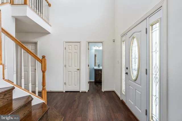 a view of an entryway with wooden floor and stairs
