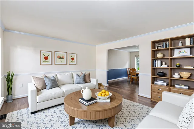 a living room with furniture and a book shelf