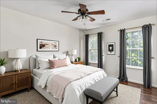 a bedroom with a large bed and a chandelier