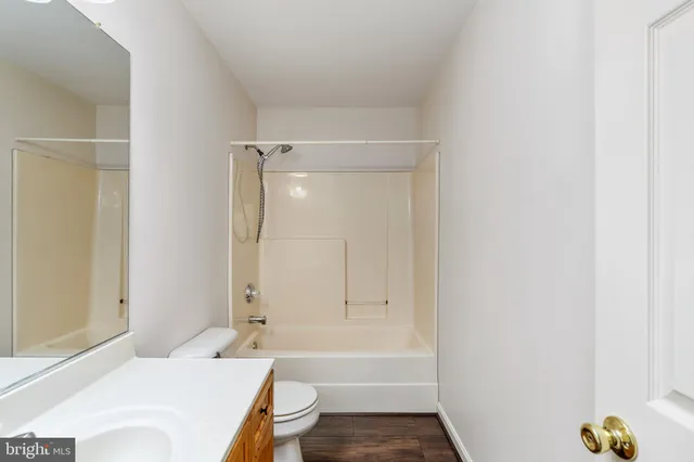 a bathroom with a sink a toilet and bathtub