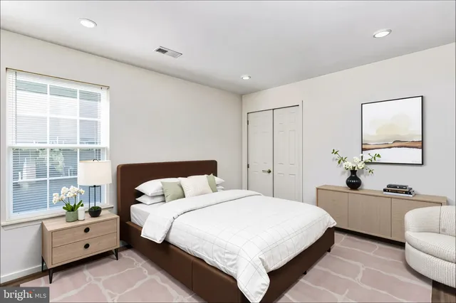 a bedroom with a bed and a couch