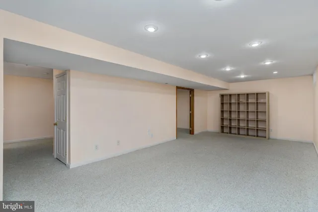 a view of an empty room with closet and window