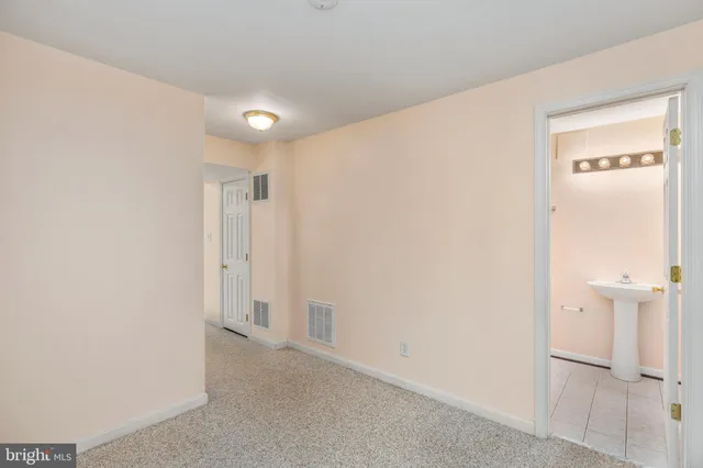 a view of a hallway with closet and bathroom