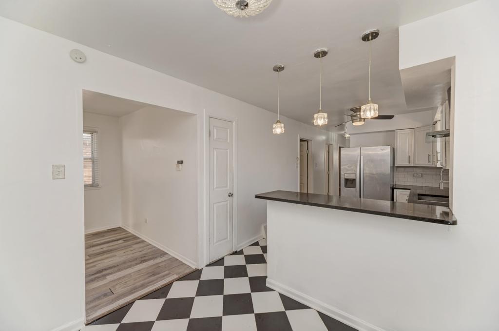 1472 West 74th Street Chicago, IL 60636 - Photo 11 of 32 a kitchen with granite countertop a refrigerator and a sink