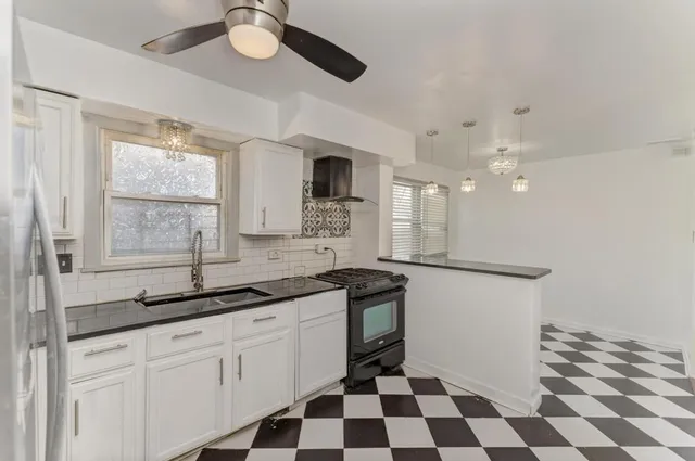 a kitchen with a sink a counter and cabinets