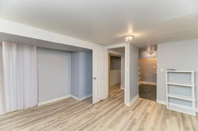 an empty room with closet and wooden floor