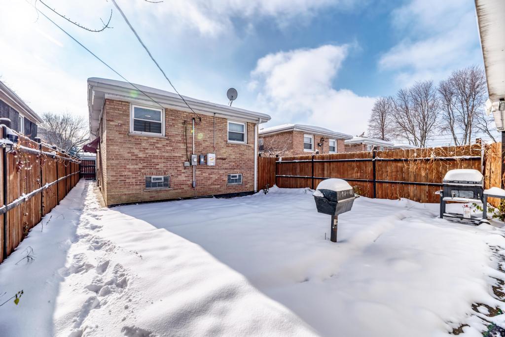 1472 West 74th Street Chicago, IL 60636 - Photo 30 of 32 a view of roof deck with table and chairs potted plants with wooden fence