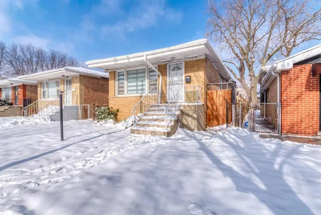 a view of a house with snow on the road