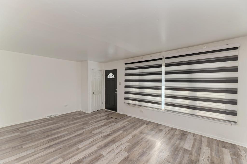 1472 West 74th Street Chicago, IL 60636 - Photo 5 of 32 a view of a bedroom with a bed and a window