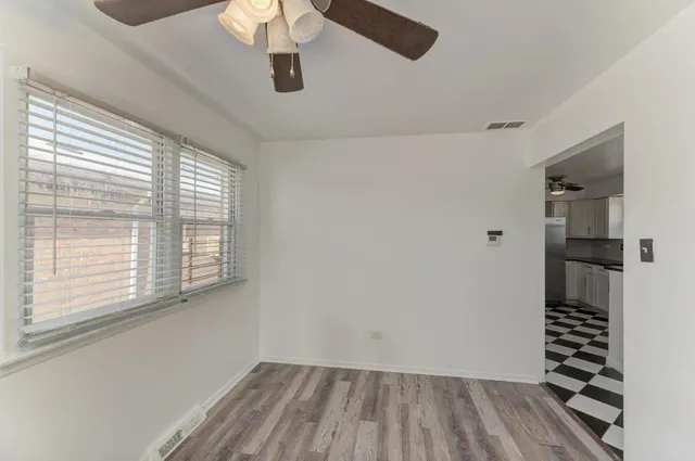 a view of wooden floor and windows in a room
