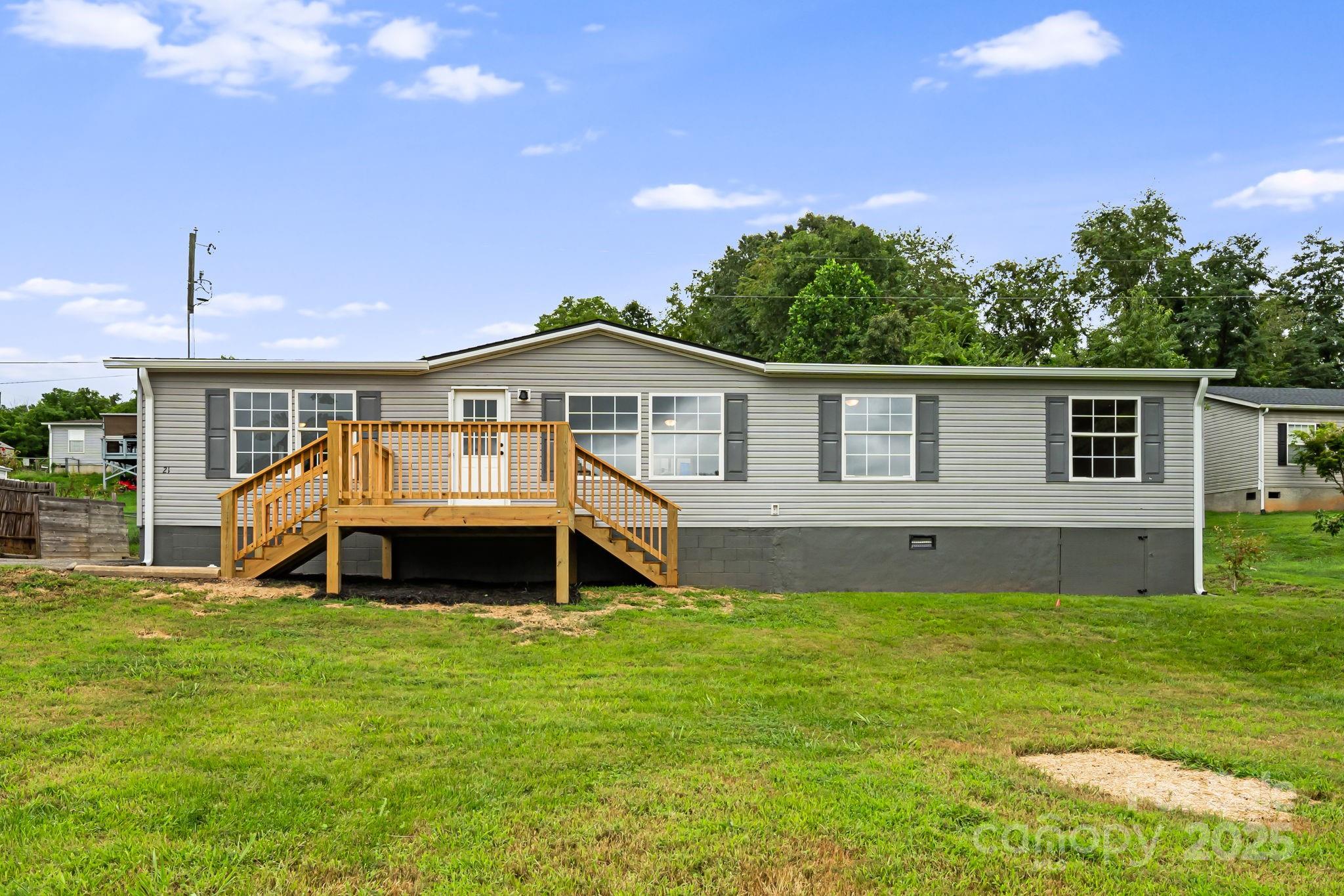 21 Toms Road Candler, NC 28715 - Photo 2 of 29 a front view of a house with a garden and yard