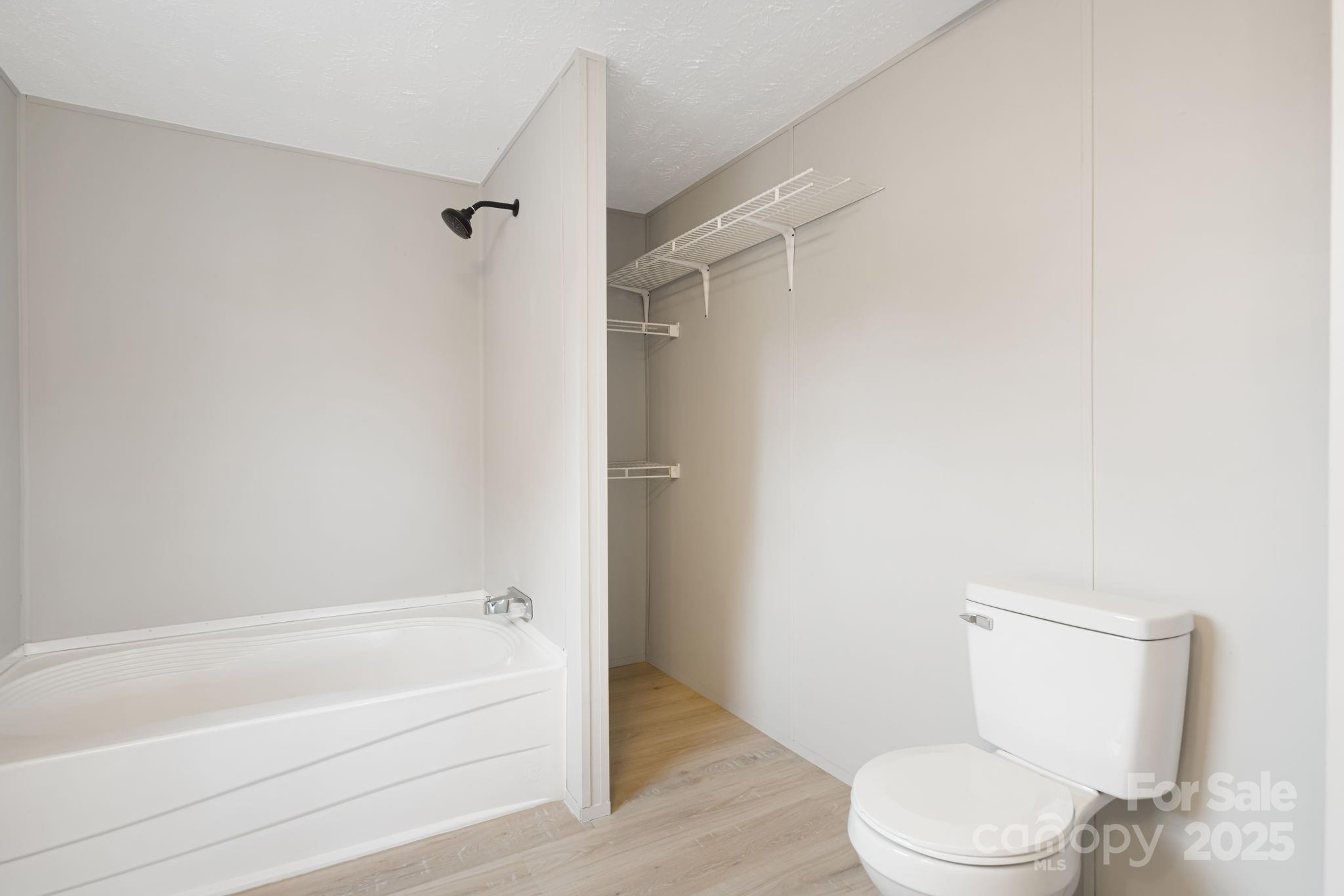 21 Toms Road Candler, NC 28715 - Photo 25 of 29 a bathroom with a toilet and a bathtub