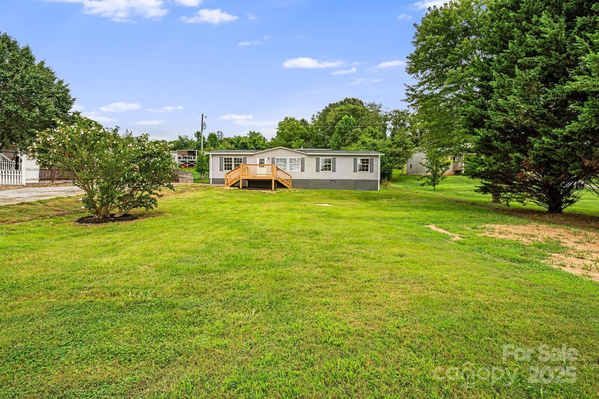 21 Toms Road Candler, NC 28715 - Photo 29 of 29 a backyard of a house with a yard and outdoor seating