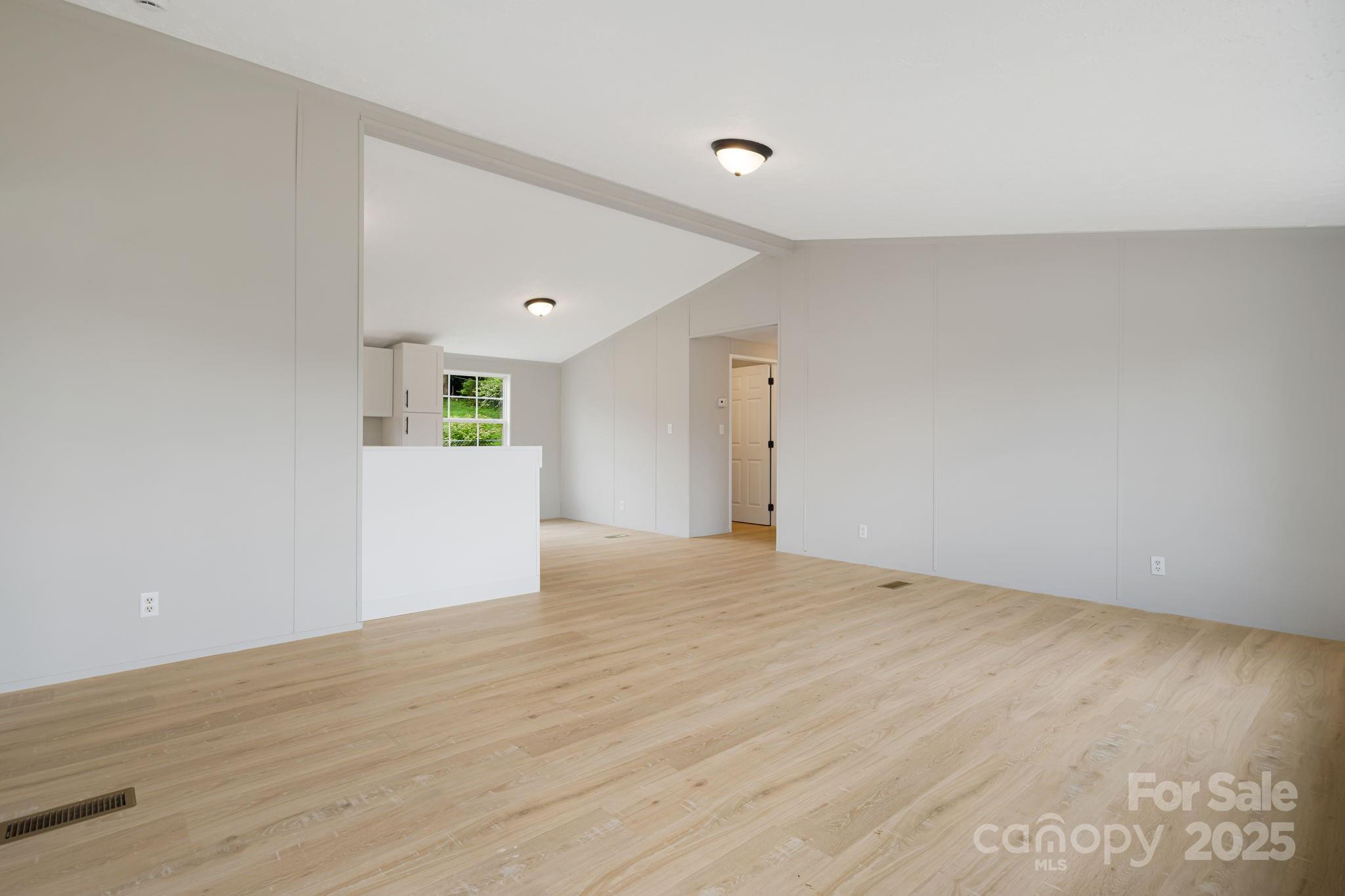 21 Toms Road Candler, NC 28715 - Photo 5 of 29 a view of an empty room with wooden floor