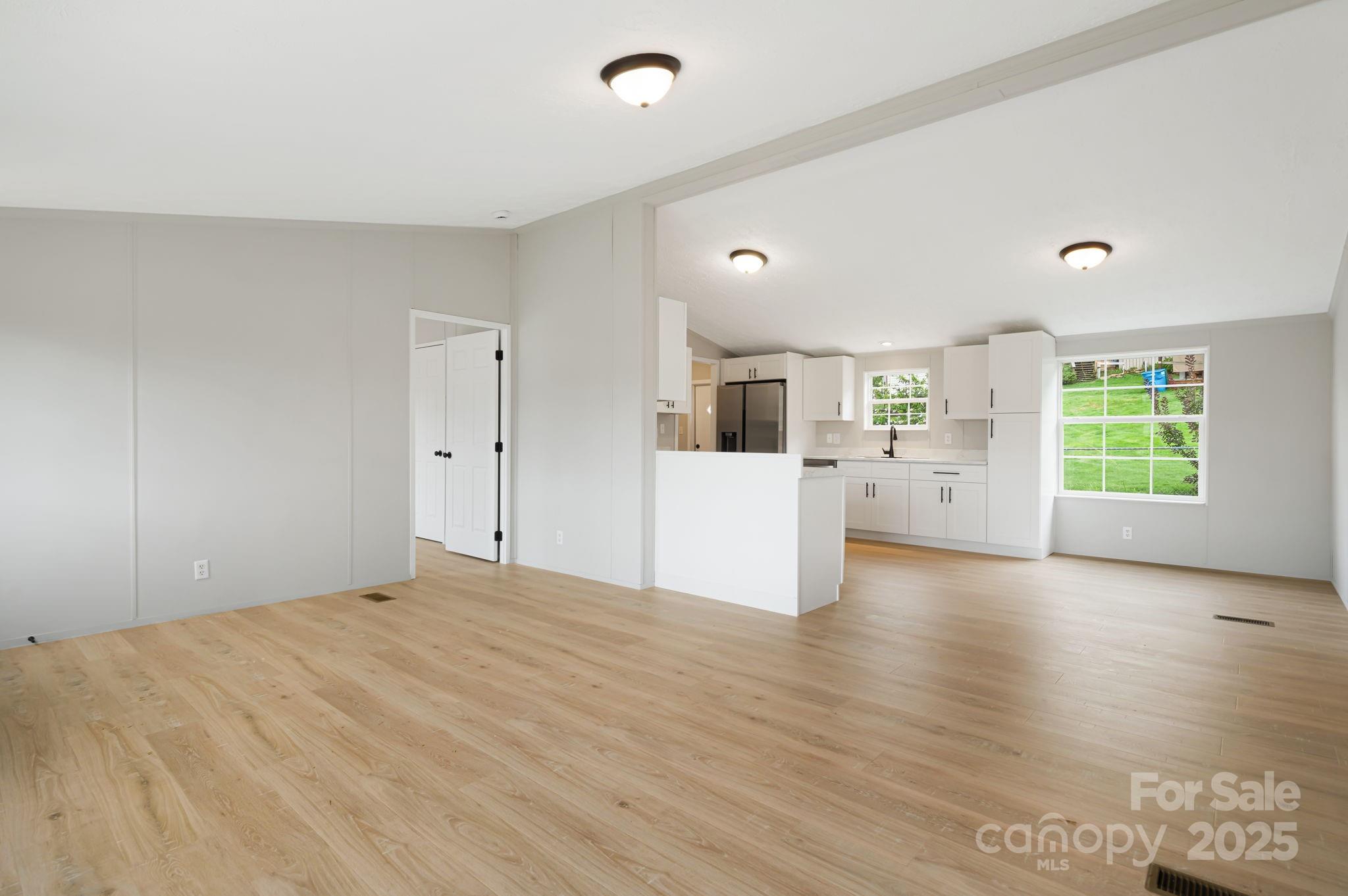21 Toms Road Candler, NC 28715 - Photo 6 of 29 a big room with wooden floor and windows