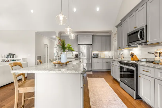 a bedroom with a bed a window and dresser