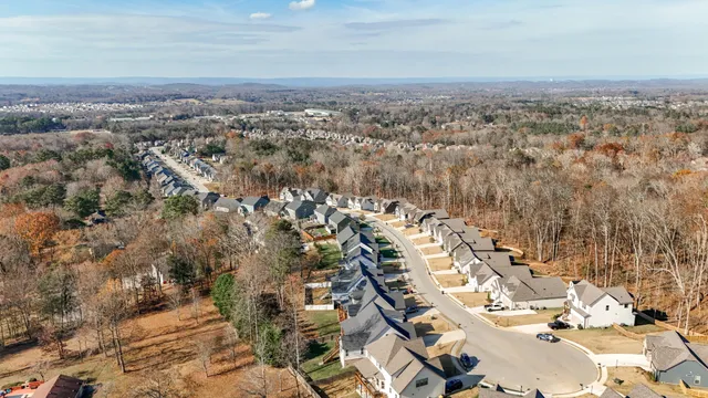 a view of a white house with a yard and potted plants