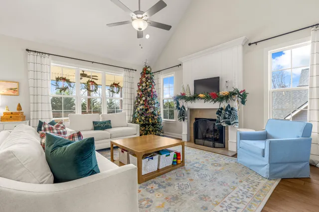 a kitchen with stainless steel appliances a dining table chairs and wooden floor