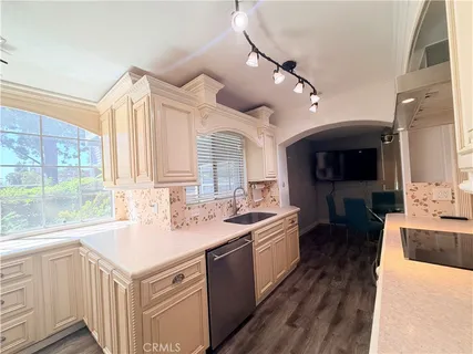 a kitchen with a sink stove top oven and refrigerator