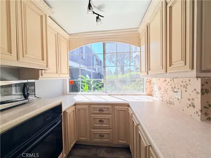 a kitchen with a sink stove and cabinets