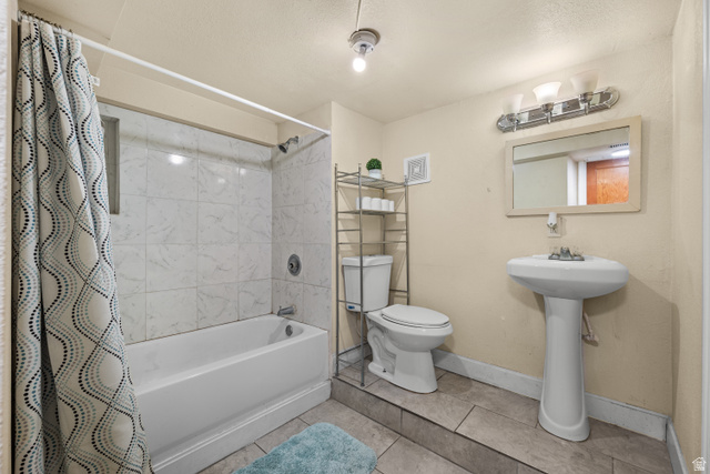 88 East C Street Springville, UT 84663 - Photo 25 of 32 Full bathroom featuring a white bathtub, white tiled shower surround, pedestal sink, and tiled flooring