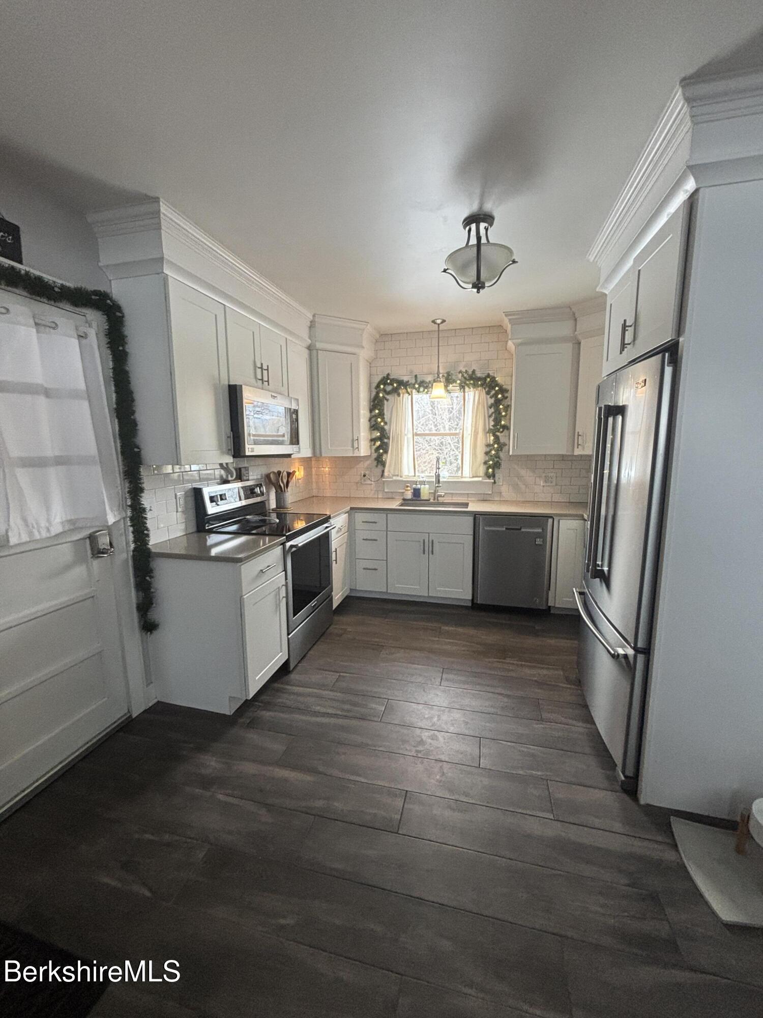 115 Luce Road Williamstown, MA 01267 - Photo 3 of 20 a kitchen with stainless steel appliances a refrigerator a sink dishwasher a stove top oven a refrigerator and cabinets