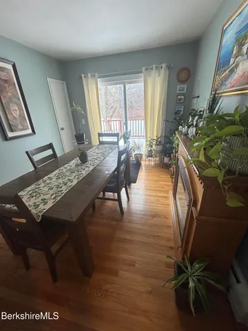 a view of a livingroom with furniture window and wooden floor
