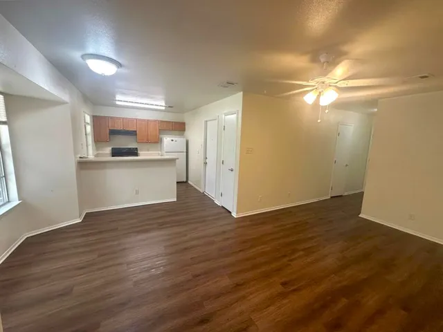 a view of a kitchen with wooden floor and a sink
