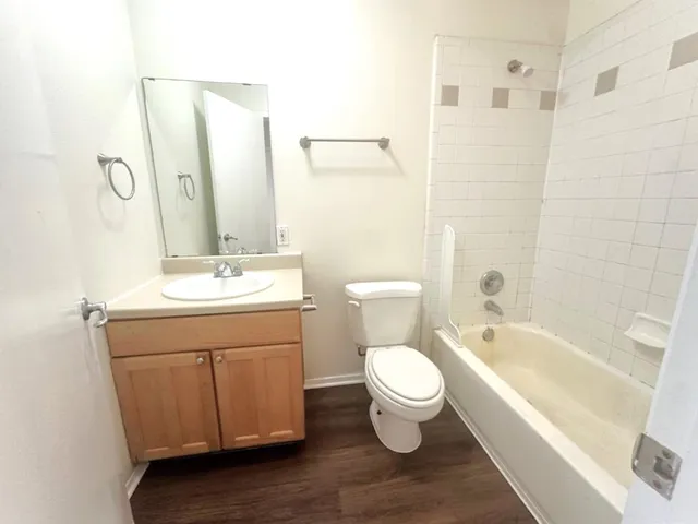 a bathroom with a sink toilet a mirror and shower
