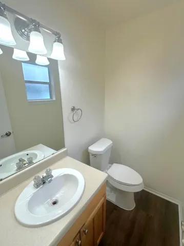a bathroom with a sink a toilet and mirror