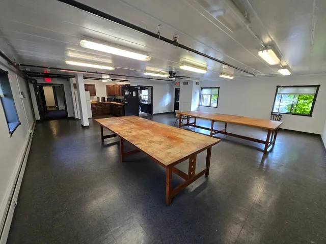 a room with gym equipment and a table