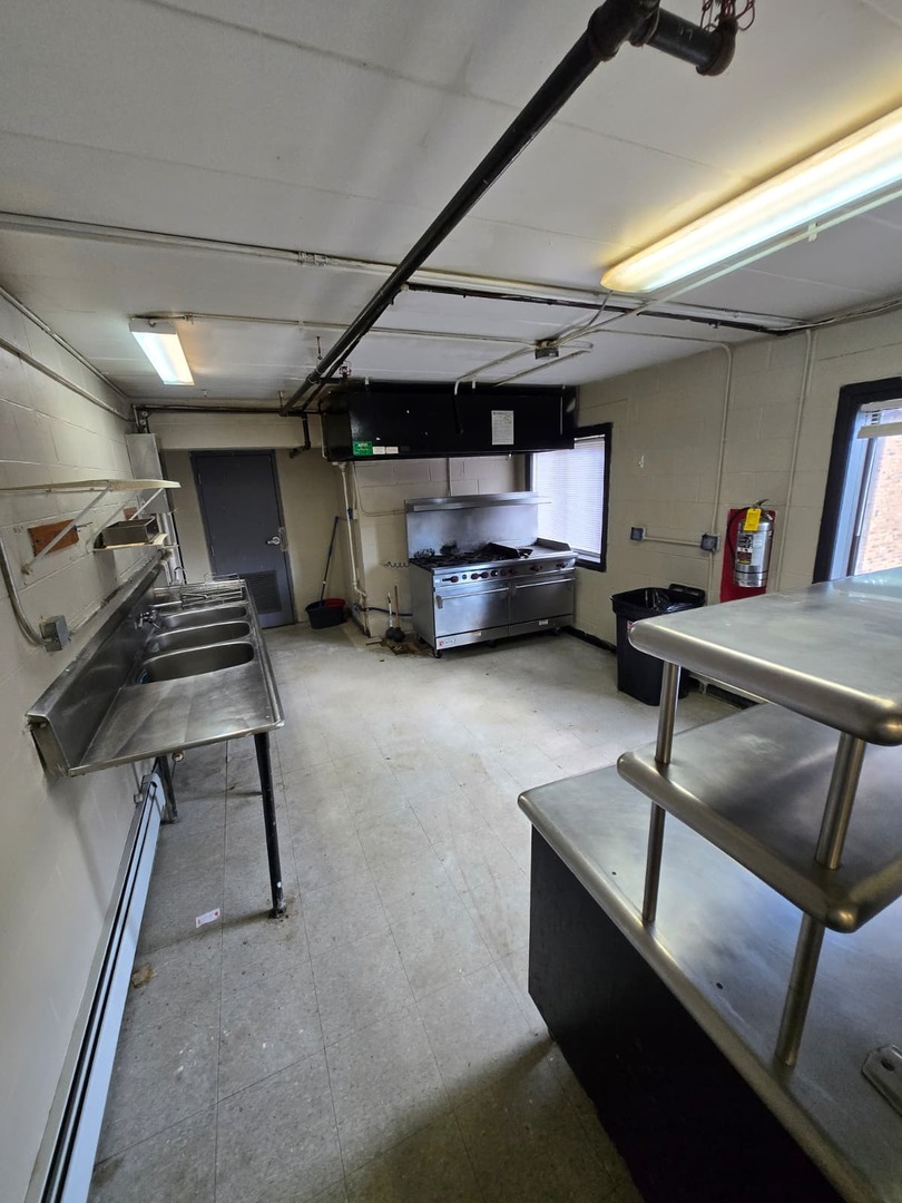 924 Greenbrier Road DeKalb, IL 60115 - Photo 13 of 20 a room with gym equipment and a table