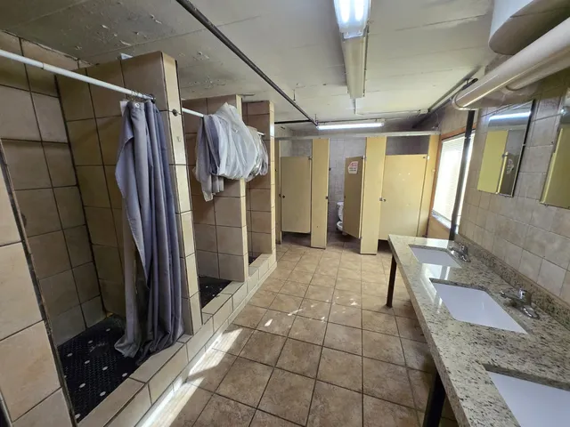 a hallway with a black white checkered floor and a large window