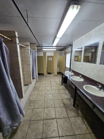 a view of a porch with a table and chairs under an umbrella