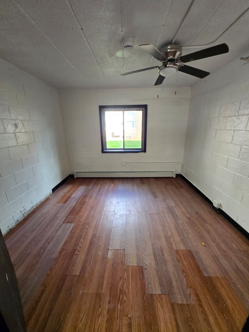 924 Greenbrier Road DeKalb, IL 60115 - Photo 4 of 20 wooden floor in an empty room with a window