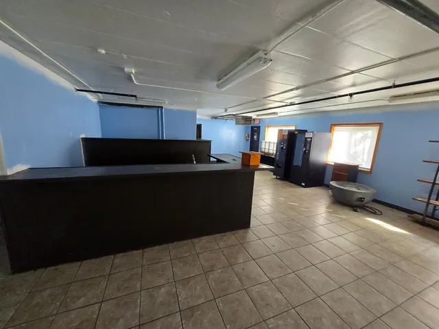 a kitchen with granite countertop a refrigerator and a sink
