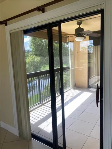 a view of a glass door with a trees from a glass door