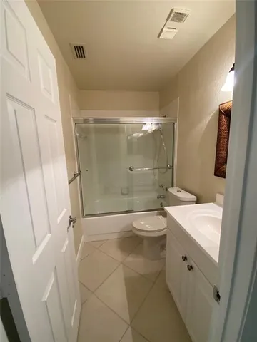 a bathroom with a double vanity sink toilet and shower