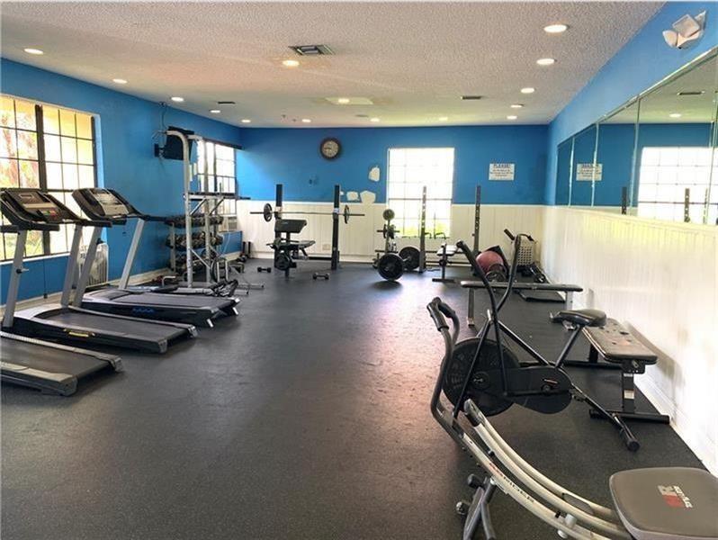 5701 Riverside Drive, Unit 302 Coral Springs, FL 33067 - Photo 20 of 21 a view of a room with gym equipment
